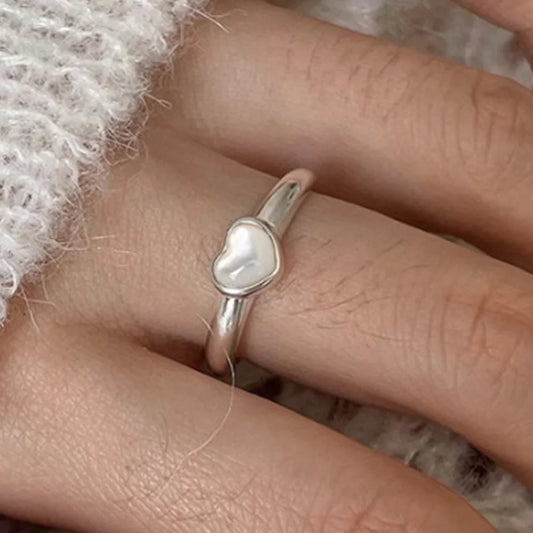 A stunning rose quartz ring, symbolizing love and compassion, set in a minimalist band